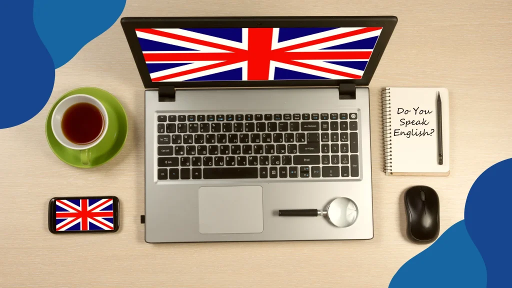 Refundacja na naukę języków obcych – laptop i smartfon z flagą brytyjską, notes z napisem „Do You Speak English?”