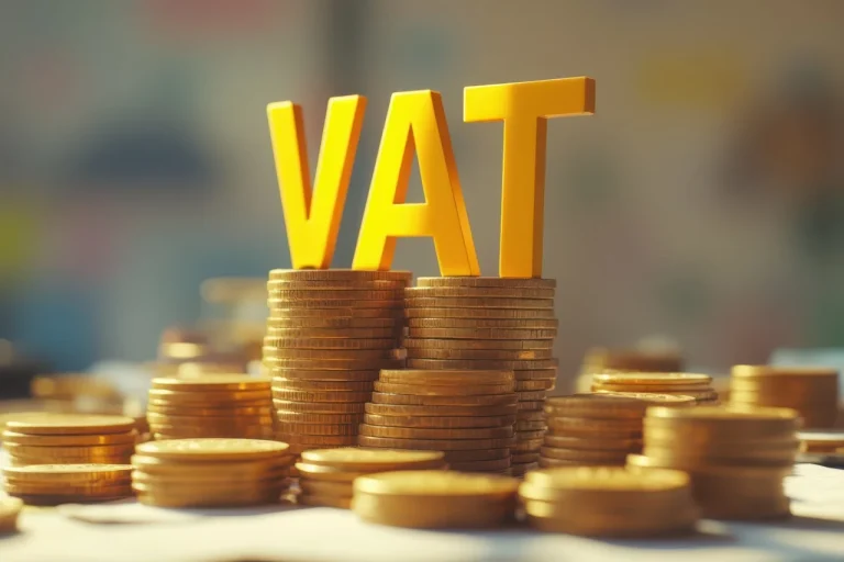 Zasady rozliczania podatku VAT w przypadku barteru – litery „VAT” na stosach złotych monet