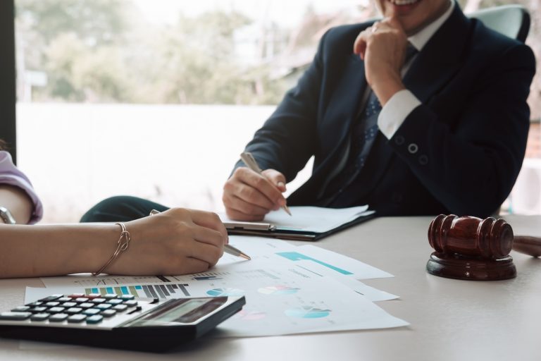Consultation between business and lawyer about the tax laws disc