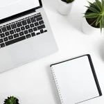 Szkolenie z Kodeksu postępowania administracyjnego – laptop, notes, filiżanka kawy i rośliny na białym blacie